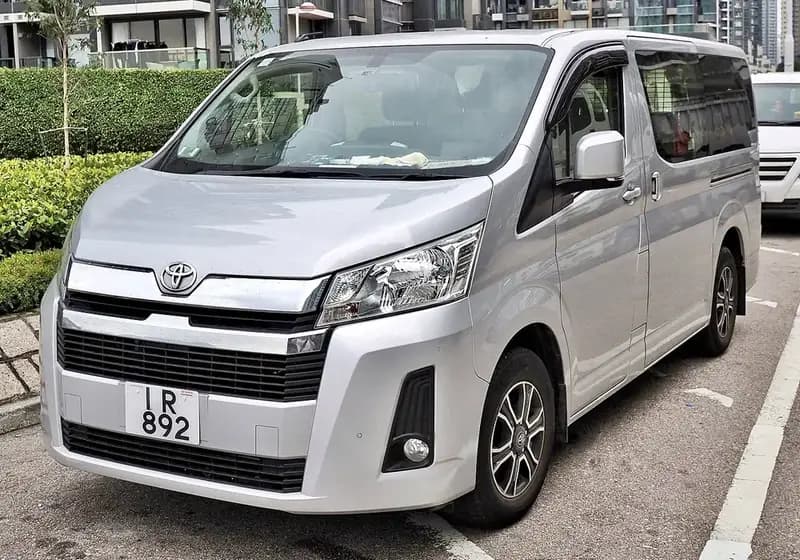 A white Hiace van parked in a rugged landscape