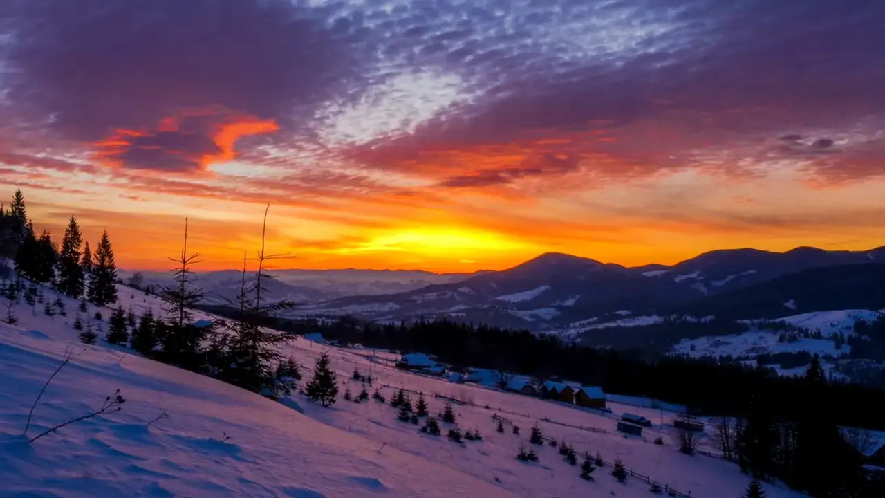 Snowy mountain valley at sunset