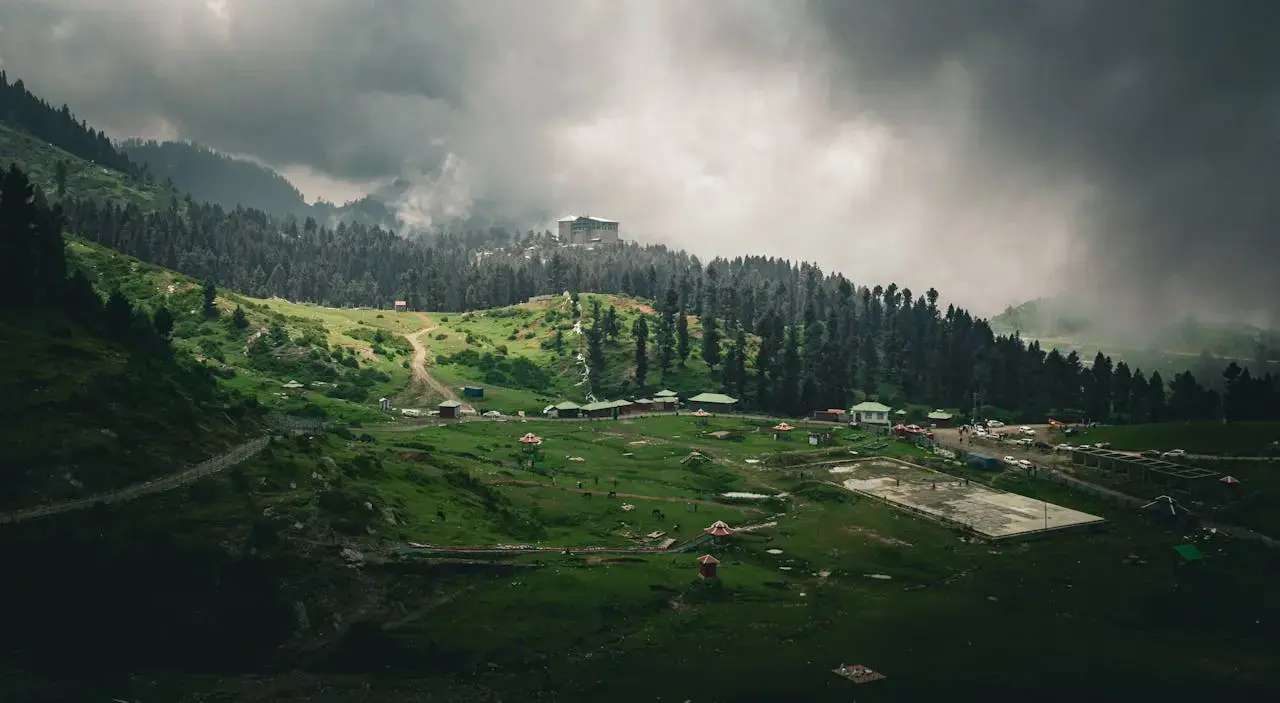 Lush green Malam Jabba hills and forest under an overcast sky