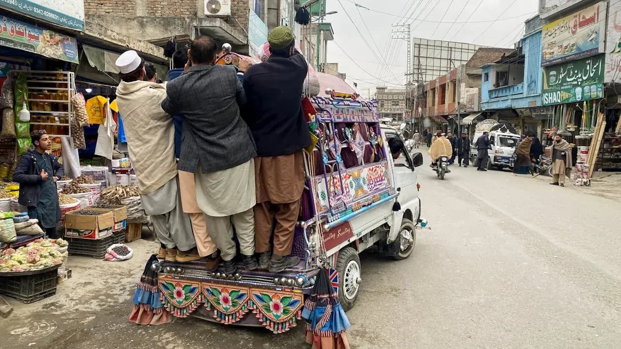 Colorful public transport and market activity in Mingora, Swat