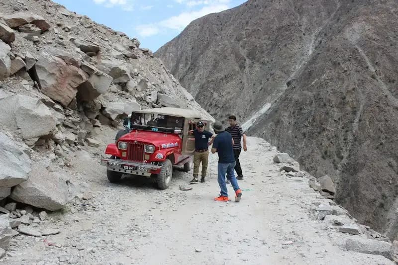 A red jeep traversing rocky terrains in Gilgit-Baltistan
